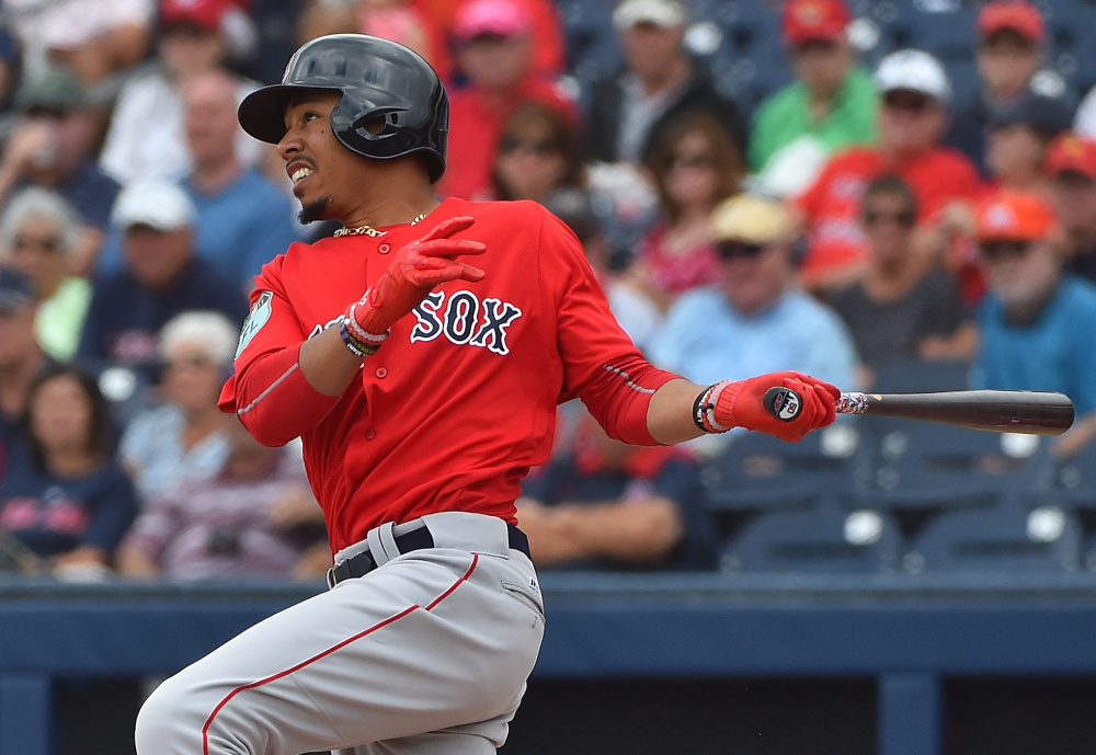 Mookie Betts of the Red Sox hits a first-inning home run Tuesday against the Nationals at The Ballpark of the Palm Beaches in West Palm Beach, Fla. The Red Sox won, 5-3.