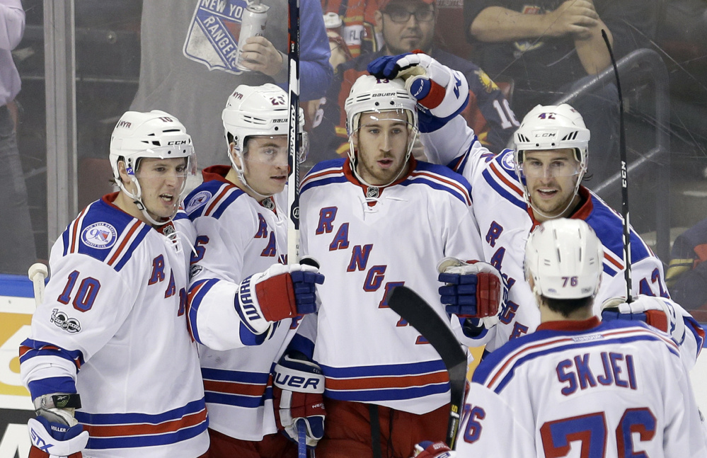 Kevin Hayes of the Rangers gets congratulated by J.T. Miller, 10, Jimmy Vesey, 26, Brendan Smith, 42, and Brady Skjei after scoring a second-period goal Tuesday night against the Panthers at Sunrise, Fla.