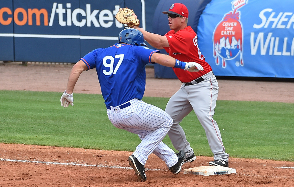 Mets designated hitter Tim Tebow is doubled off first base on a line drive during New York's 8-7 spring training victory over the Red Sox on Wednesday at Port St. Lucie, Fla. Tebow went 0 for 3 with two strikeouts.