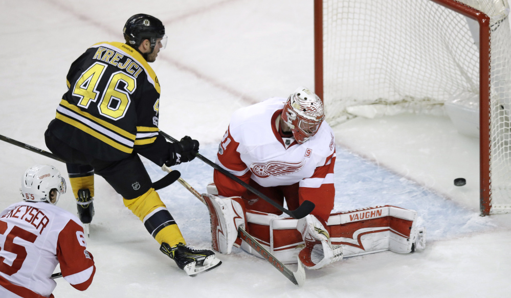 Bruins center David Krejci pokes the puck past Red Wings goalie Jared Coreau for a goal during the first period.