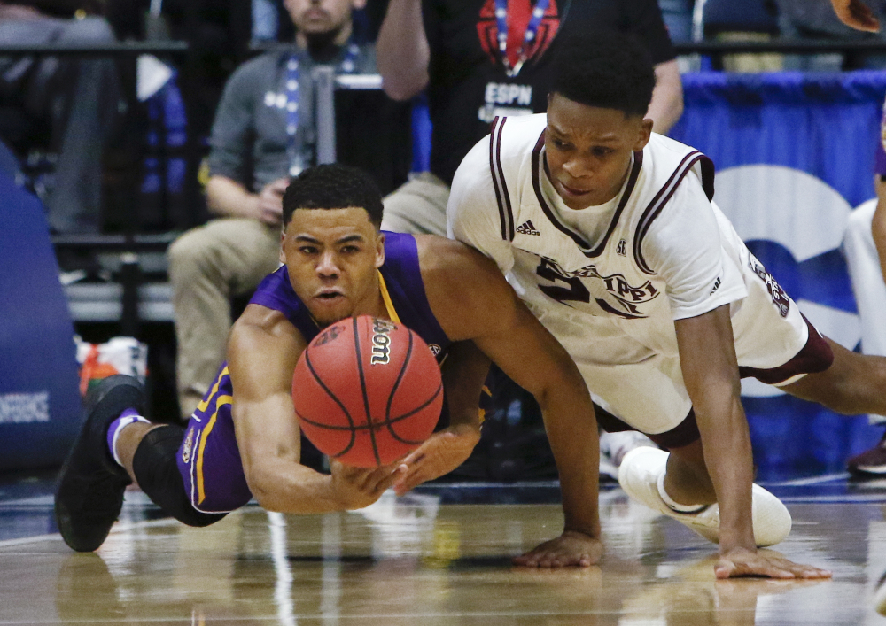 LSU guard Jalyn Patterson, left, and Mississippi State guard Tyson Carter dive for the ball during the first half of an NCAA college basketball game at the Southeastern Conference tournament Wednesday, March 8, 2017, in Nashville, Tenn. (AP Photo/Wade Payne)
