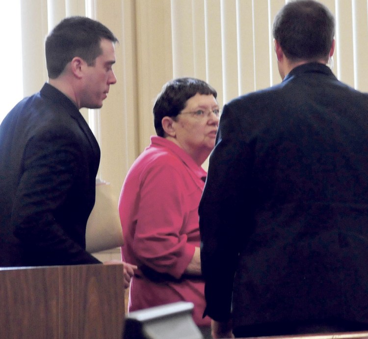 Mary O'Donal and her attorney, Christopher Berryment, left, speak with a court officer after O'Donal was sentenced Thursday in Franklin County Superior Court to three years in prison, with all but 30 days suspended, and ordered to pay restitution for stealing more than $300,000 from the Care and Share Food Closet in Farmington.
