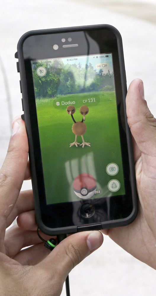Doduo, a Pokemon, is found by a group of "Pokemon Go" players using a smartphone at Bayfront Park in Miami last July.
