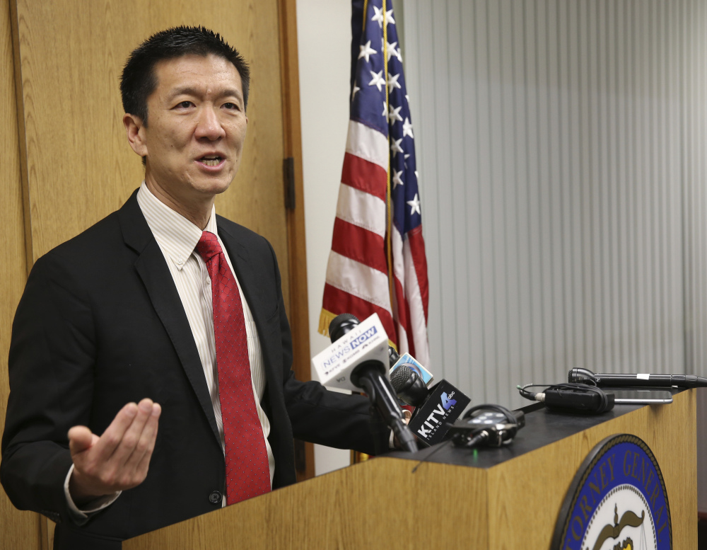 Hawaii Attorney General Douglas Chin speaks at a news conference Thursday. Chin's office filed an amended lawsuit against President Trump's revised travel ban.