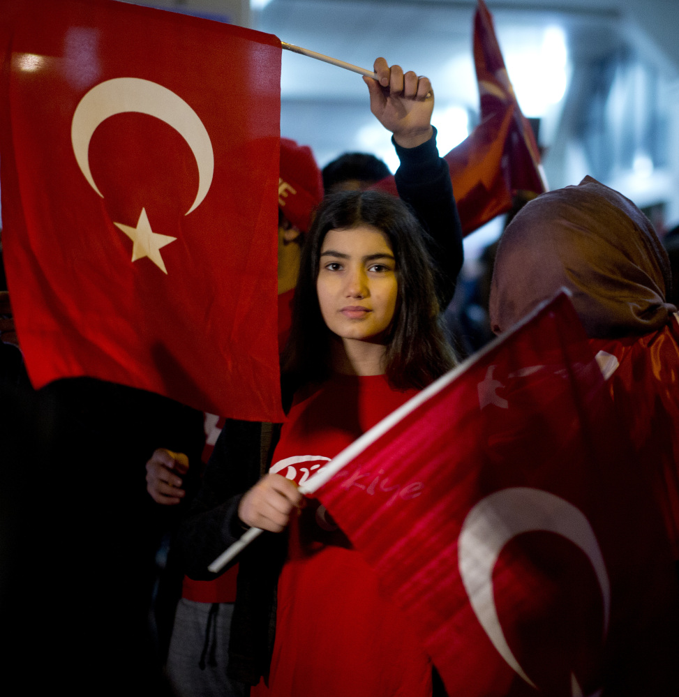 Demonstrators wave Turkish flags outside the Turkish consulate Saturday in Rotterdam, where Turkish Foreign Minister Mevlut Cavusoglu was due to campaign for a referendum next month on constitutional reforms in Turkey.