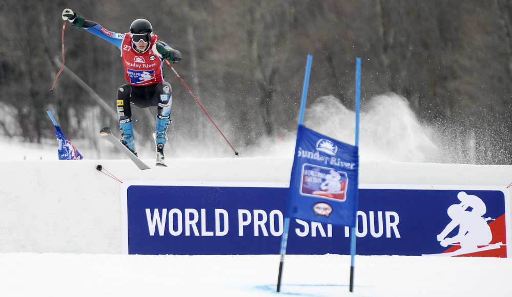 Henry Townsend of Winthrop takes a jump while going down the course during the World Ski Tour at Sunday River on Friday. The format has skiers racing side-by-side over jumps and around tight gates. One attraction is amateur skiers receive the opportunity to compete against professionals.