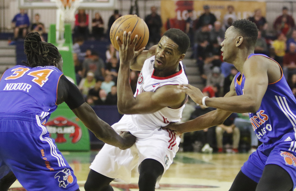 Maine's Demetrius Jackson drives while being defended by Westchester's Maurice Ndour, left, and Kevin Capers during the Red Claws' 93-85 win Sunday at the Portland Expo.