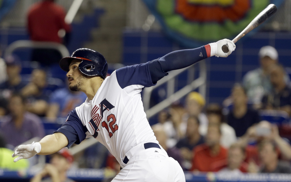 Nolan Arenado of the United States follows through on a three-run homer Sunday night in the second inning of an 8-0 victory against Canada in the World Baseball Classic in Miami.