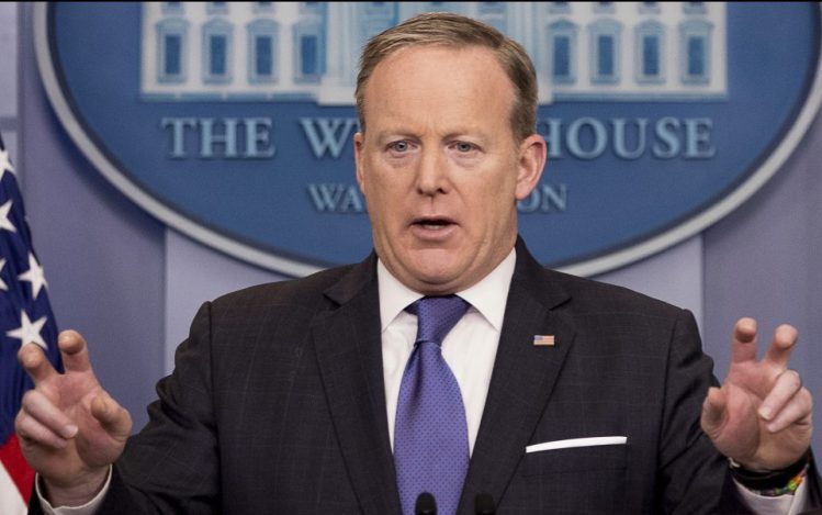 Press secretary Sean Spicer speaks during the daily press briefing at the White House on Monday. Spicer tried to clarify President Trump's comments, saying, "The president used the word wiretap in quotes to mean broadly surveillance and other activities."