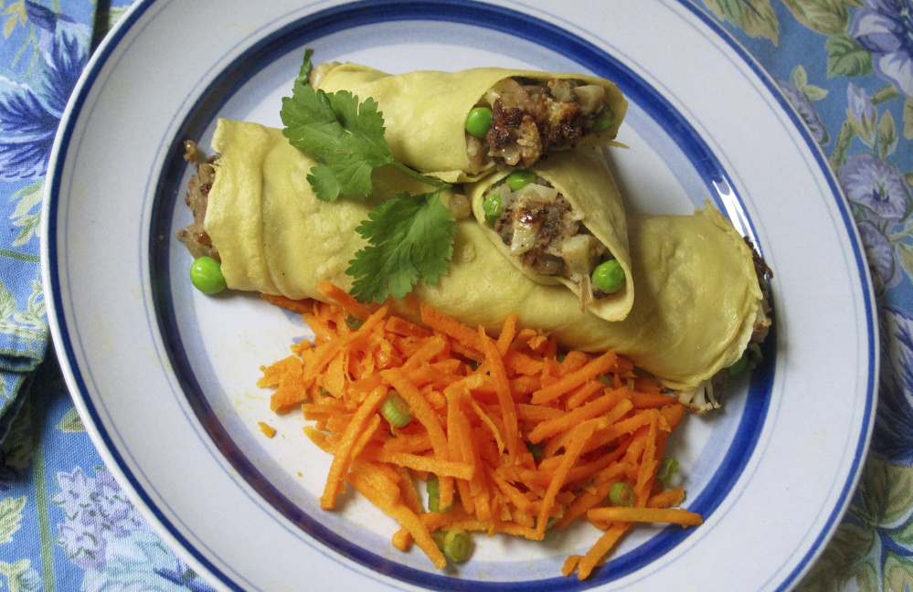 Chickpea crepes stuffed with Indian spiced potatoes and peas.