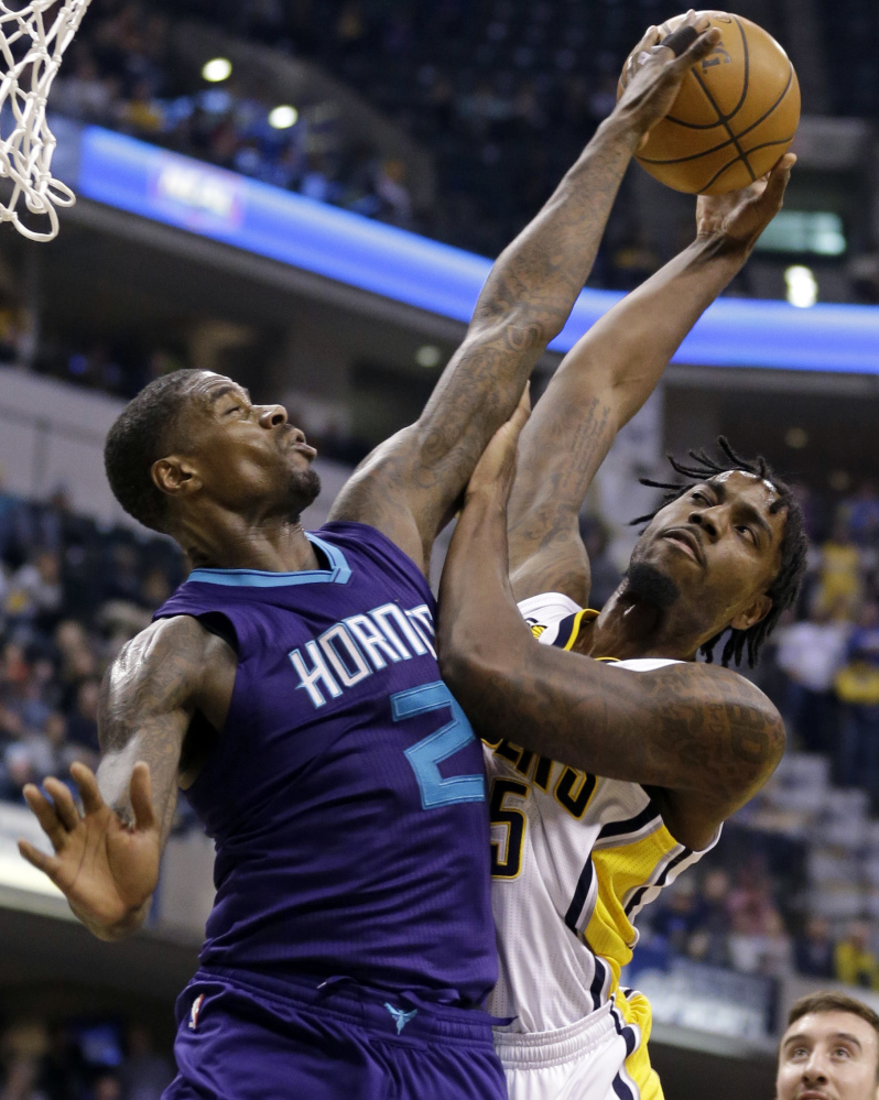 Charlotte Hornets forward Marvin Williams, left, blocks the shot of Indiana Pacers forward Rakeem Christmas during the second half of a 98-77 win by the Pacers on Wednesday at Indianapolis.