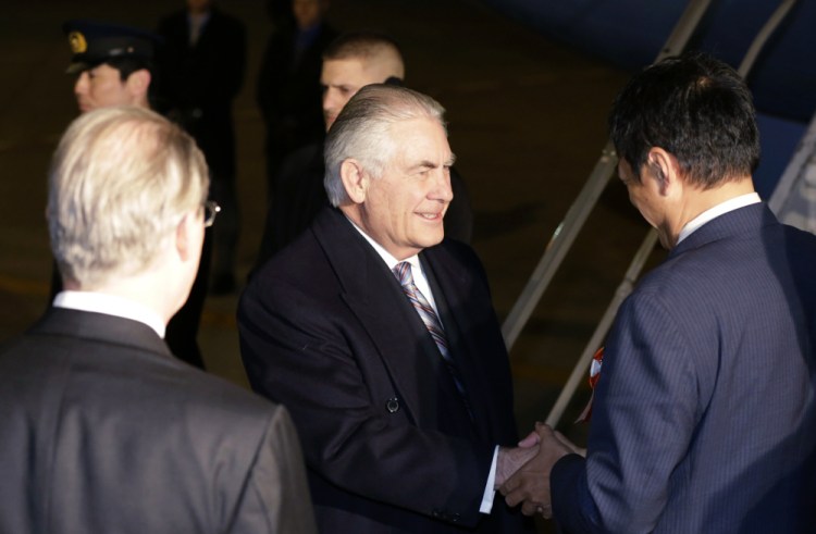 U.S. Secretary of State Rex Tillerson, center, is greeted Wednesday at Haneda International Airport in Tokyo, the first stop on a trip that will include visits to China and South Korea.