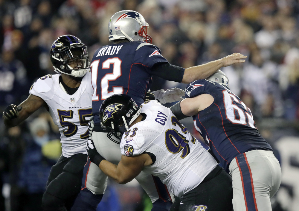 Defensive end Lawrence Guy, bottom, had many chances to sack Tom Brady over the past three seasons as a member of the Ravens. This season, though, Guy looks forward to being a part of the New England franchise.  "I never thought it was possible for me to join the Patriots," Guy said.