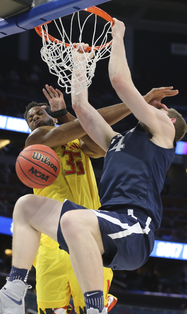 Sean O'Mara, who finished with 18 points for Xavier, dunks against Damonte Dodd of Maryland during the first half of Xavier's 76-65 victory Thursday. O'Mara shot 5 of 6 from the field.