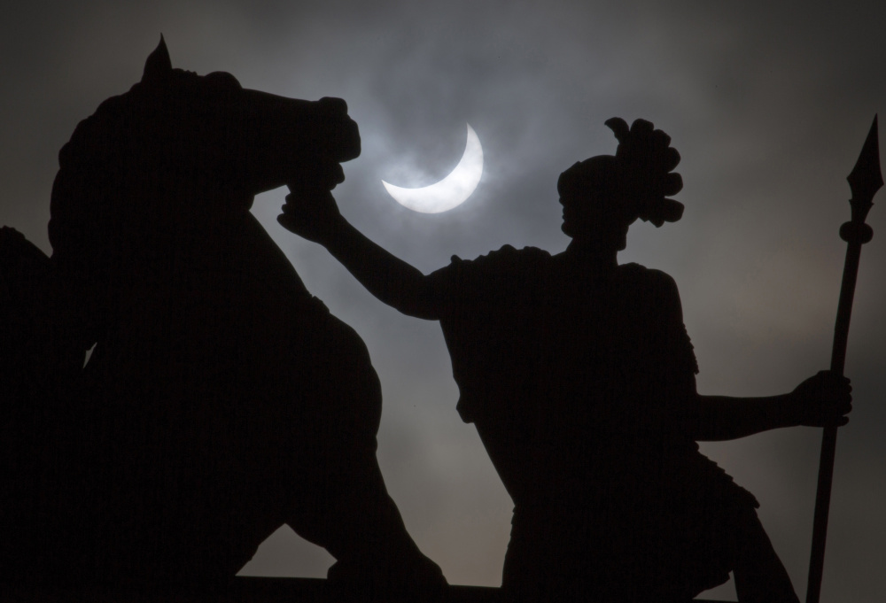 A solar eclipse in 2015 adds a dramatic flair to a statue in St. Petersburg, Russia. Weather permitting, people in a large swath of the United States will be able to see a total elipse on Aug. 21.
Associated Press/
Dmitry Lovetsky