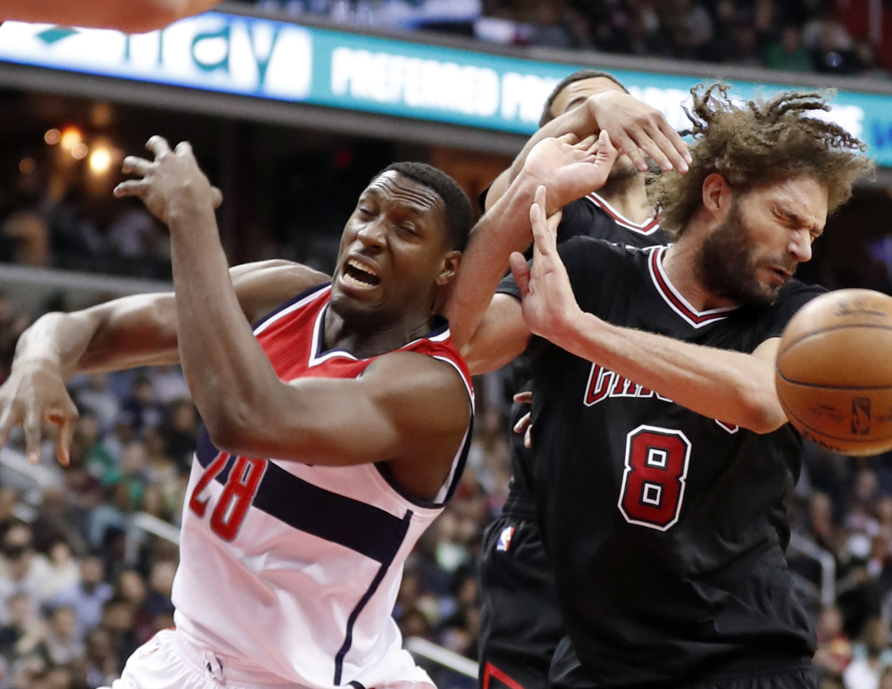 Washington center Ian Mahinmi, left, and Chicago center Robin Lopez can't find the handle on a loose ball underneath the basket during a 112-107 win by the Wizards Friday at Washington.