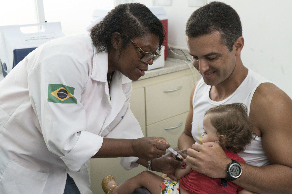 A nurse vaccinates a toddler against yellow fever at clinic in Rio de Janeiro, Brazil. Rio's health department says it has confirmed a fatal case of yellow fever.