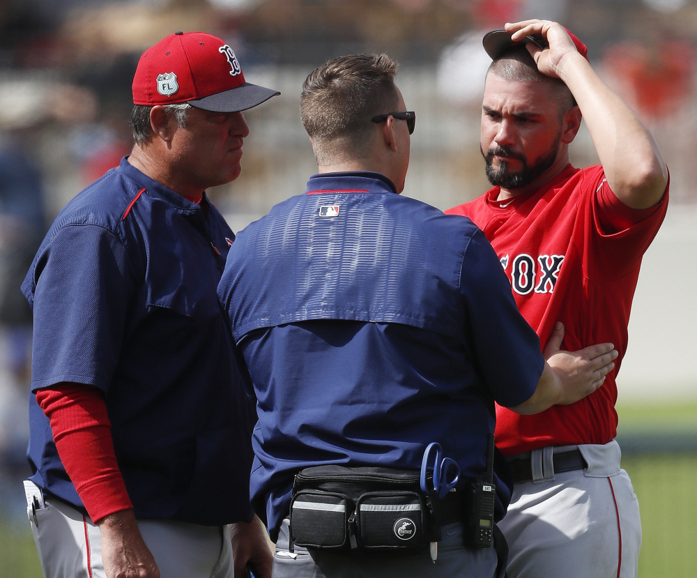 Manager John Farrell, left, and the Red Sox training staff are keeping close tabs on Robby Scott, and why not? Scott has allowed no runs and six hits in seven innings this spring.