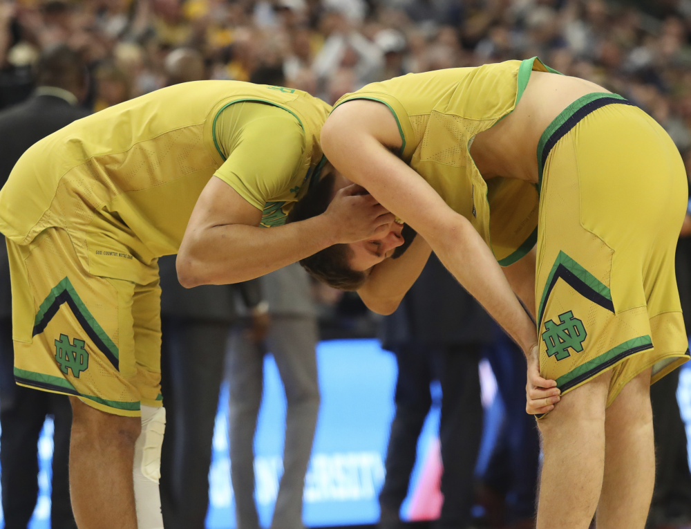 Austin Torres, left, and Matt Ryan of Notre Dame react Saturday after the 83-71 loss to West Virginia at Buffalo, N.Y., in a second-round game of the NCAA tournament. West Virginia will play Gonzaga on Thursday.