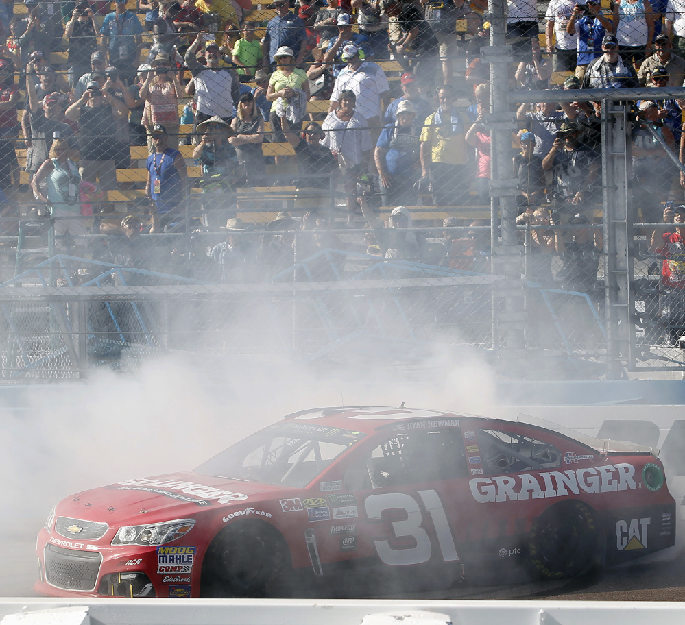 Ryan Newman does a burnout in front of the grandstands to celebrate his victory in the NASCAR Cup Series auto race at Phoenix International Raceway, Sunday, March 19, 2017, in Avondale, Ariz. (AP Photo/Ralph Freso)
