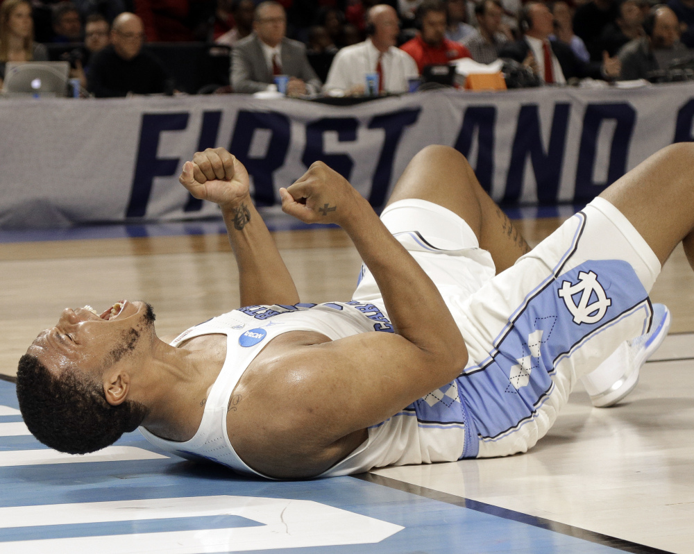 A tip-in by Kennedy Meeks in the final minute helped top-seeded North Carolina turn back an upset bid by Arkansas, as the Tar Heels finished with a 12-0 run to earn a 72-65 win Sunday in the second round of the NCAA men's basketball tournament.