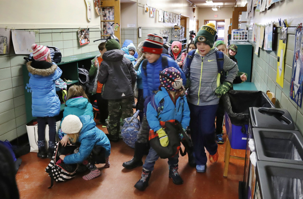 Students arrive and unpack for the start of the school day Friday at Longfellow Elementary School in Portland, one of four being considered for renovations. The largest school bond under discussion, for $64 million, mostly addresses health, safety and learning issues.