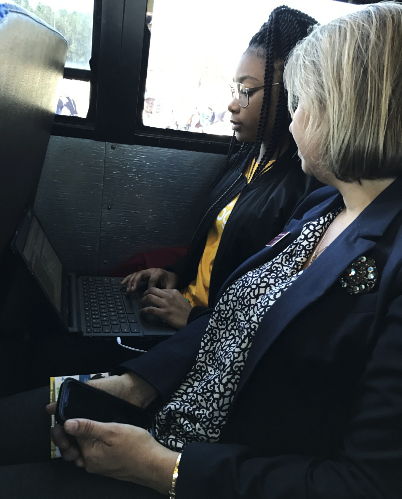 Middle school student Lakaysha Governor works Monday on her Chromebook while riding a school bus outfitted with Wi-Fi by Google. The tech giant hopes to help expand the use of Wi-Fi on school buses in other rural areas of the country.