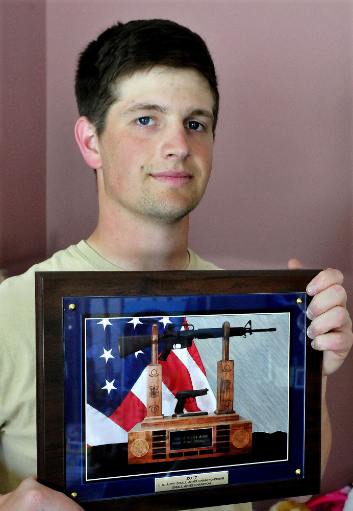 National Guardsman Max Nickerson holds an award for overall profiency with both a rifle and a handgun, presented to him at the U.S. Army Small Arms Championships.