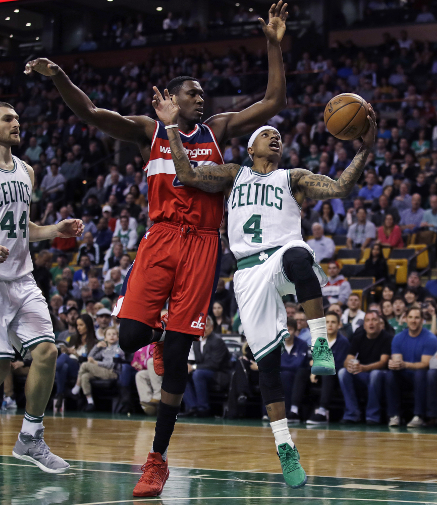 Celtics guard Isaiah Thomas drives to the basket against Wizards center Ian Mahinmi in the first quarter of the Celtics' 110-102 win. Thomas finished with 25 points, after missing two games because of a bruised right knee.