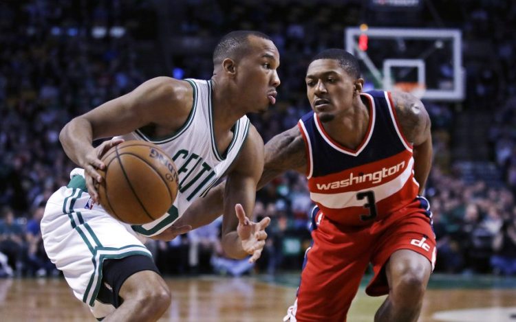 Celtics guard Avery Bradley sets to drive to the basket against Wizards guard Bradley Beal in the first quarter of Monday night's game in Boston.