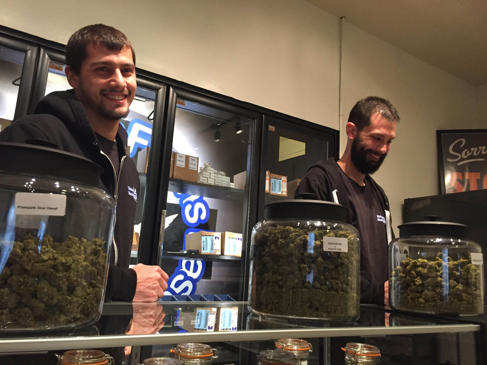 Steve Meland, left, and Jeremy Breton are co-owners of Hotbox Farms, one of two marijuana dispensaries in Huntington, Oregon, a city that has been dying but has hopes new sales tax revenue will help revive the flagging economy.