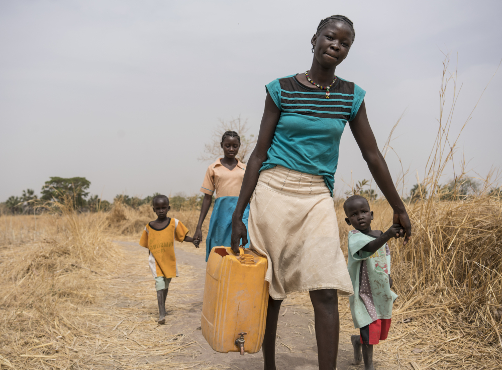 A family has to walk several miles to bring clean water to their home in South Sudan, one of multiple African countries dealing with sparse supplies of safe drinking water for a population that's growing quickly.