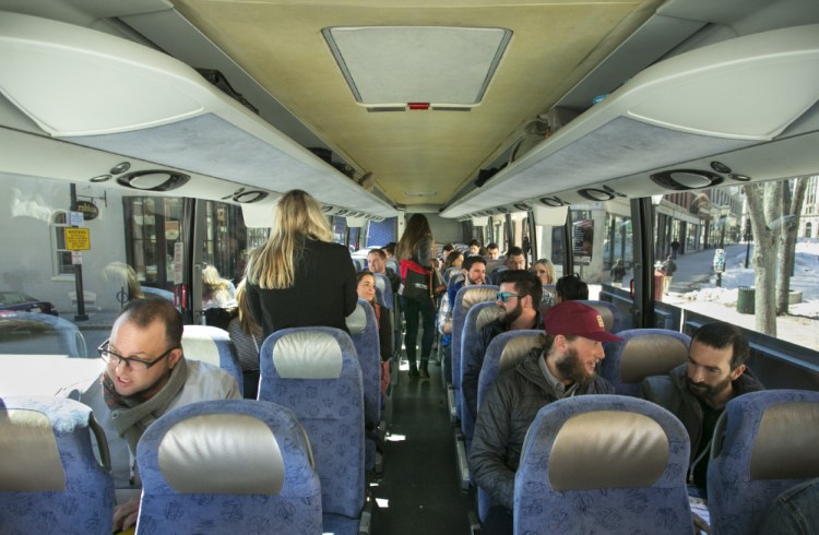 Recruiters from Maine companies board a bus in Portland and head to Boston to search for new hires on Thursday. They planned to promote Maine's quality of life as a recruiting advantage and met with workers over beer and food sourced in Maine.