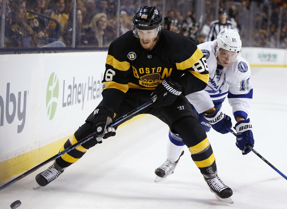 Bruins defenseman Kevan Miller looks to protect the puck from Ondrej Palat of the Tampa Bay Lightning during their game Thursday night in Boston. The Bruins lost their fourth straight, 6-3.
