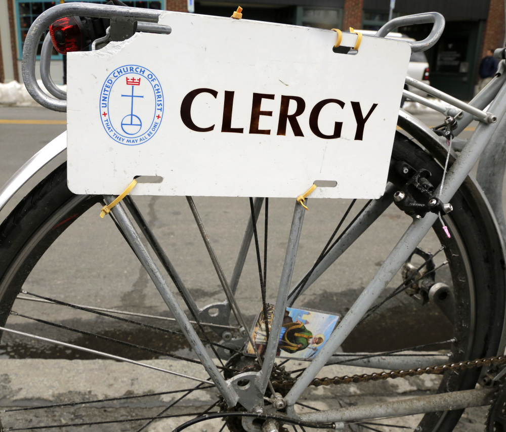 A clergy placard on a bicycle belonging to the Rev. Laura Everett, who wrote a book called "Holy Spokes."