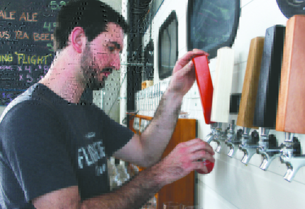 Jared Entwistle, one of the two co-owners, is the man behind the beer for the new Flight Deck Brewing at Brunswick Landing. The brewery held its grand opening on March 16.
