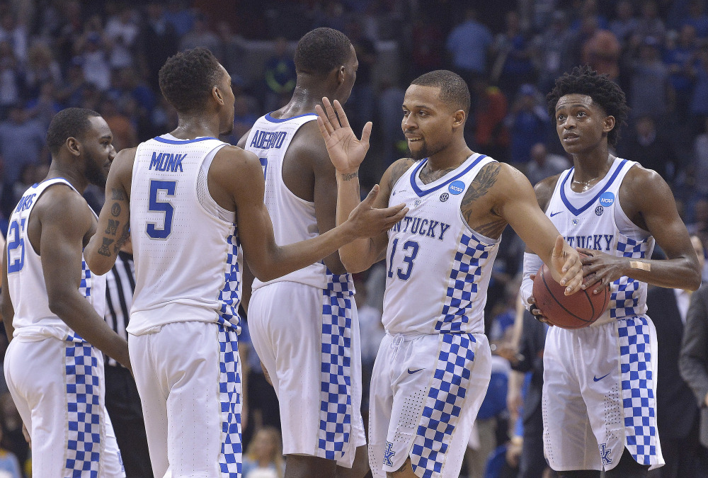 Kentucky players celebrate their 86-75 win over UCLA on Friday night in the South Regional semifinal in Memphis, Tenn.