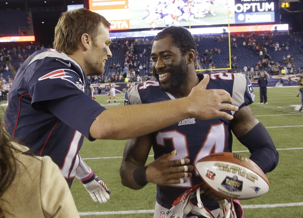Darrelle Revis, right, hugs quarterback Tom Brady after a game against the Cincinnati Bengals on Oct. 5, 2014. According to numerous reports, the free agent cornerback Revis could soon return to New England.