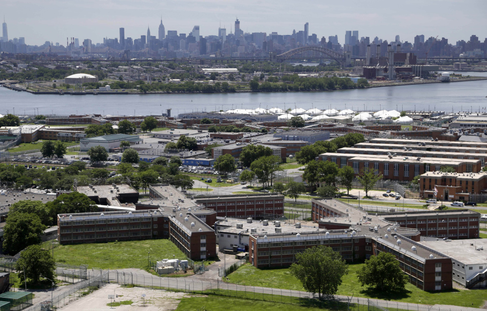 The 10-jail complex on the East River seems a world apart from the New York skyline in the backdrop.