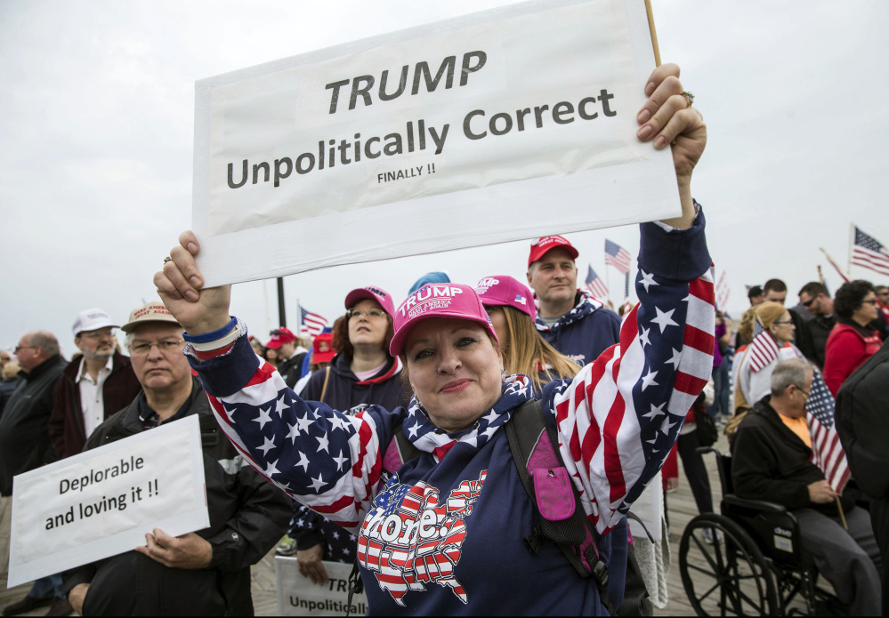 Theresa Ross of South Toms River, N.J., shows her support for President Trump during a mostly peaceful rally briefly upset by opponents Saturday on the boardwalk at Seaside Heights, N.J.