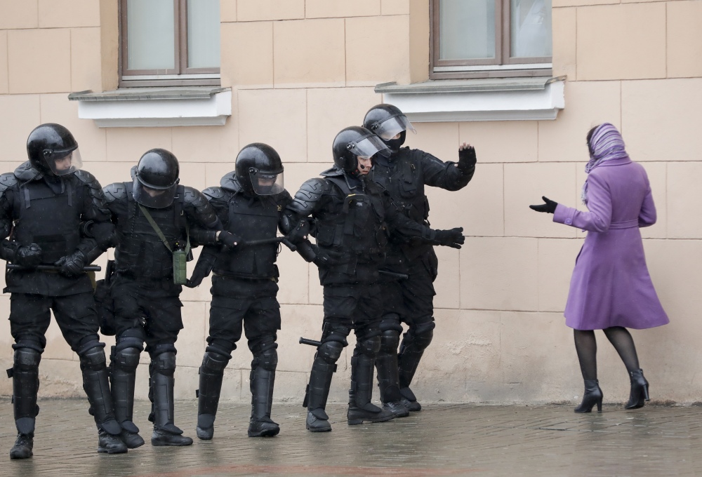 A woman tries to argue as  club-wielding Belarus police block a street during an opposition rally in the capital of Minsk on Saturday.