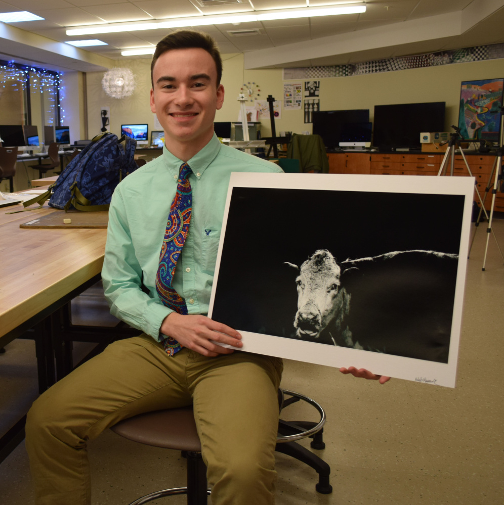 Wells High School junior Nicholas Maynard holds his winning photograph "Moo You." He received three awards and an honorable mention for artwork he entered in the 2017 National Scholastic Art and Writing Awards contest.