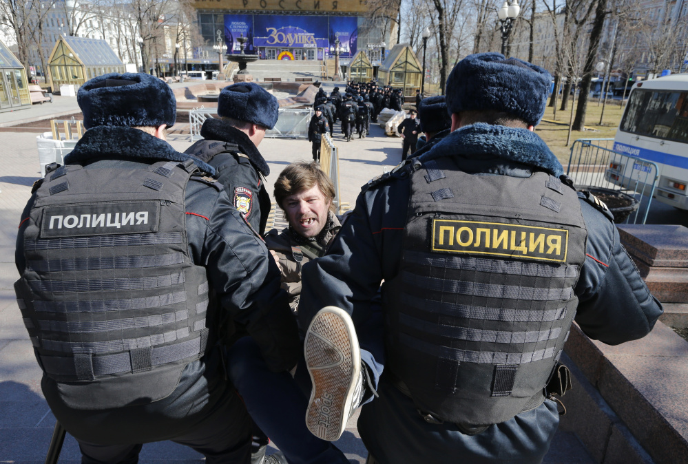 Police detain a protester in downtown Moscow on Sunday. Russia's leading opposition figure, Alexei Navalny, and his supporters held anti-corruption demonstrations throughout the country.