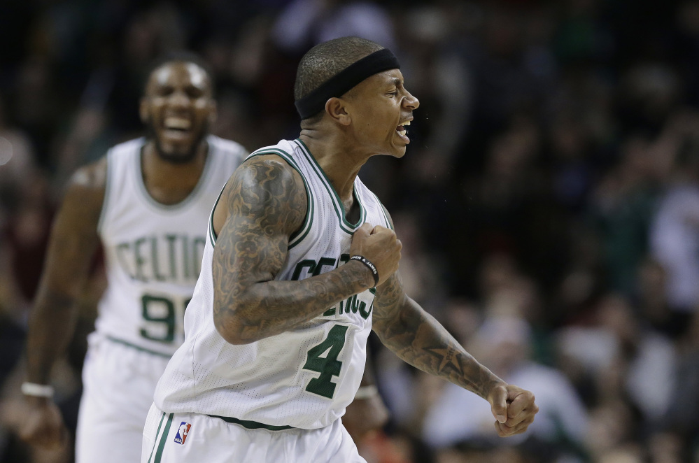 Celtics guard Isaiah Thomas celebrates after a basket in the fourth quarter Sunday against the Miami Heat. Thomas finished with 30 points in a 112-108 win.