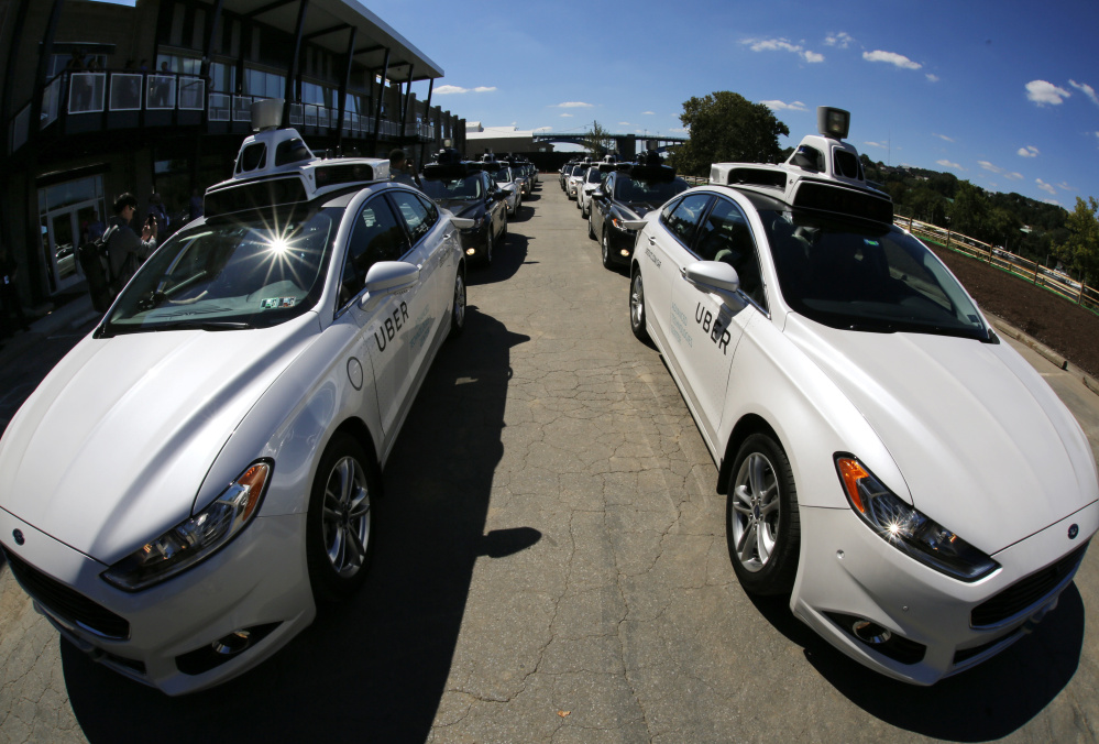 A group of self-driving Uber vehicles position themselves to take journalists on rides during a media preview at Uber's Advanced Technologies Center in Pittsburgh.