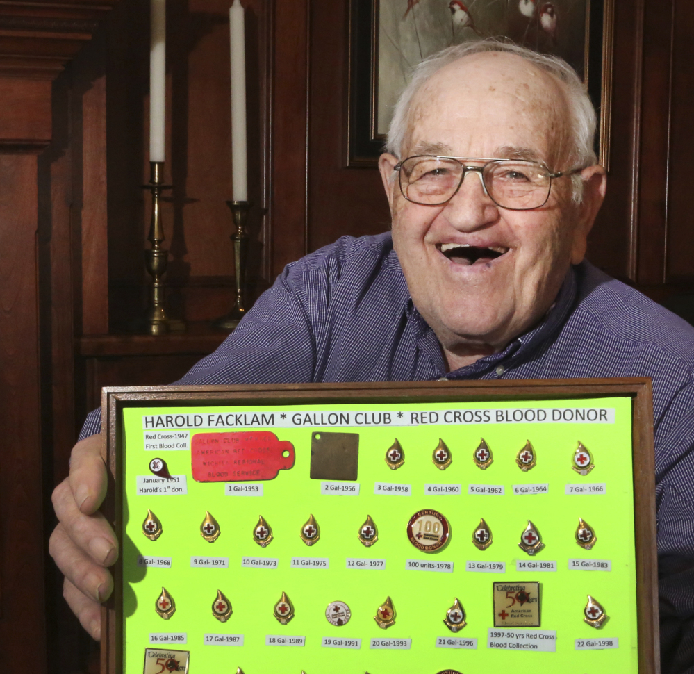 Harold Facklam Jr. displays the many pins he has collected for having donated 32 gallons of blood over more than six decades.