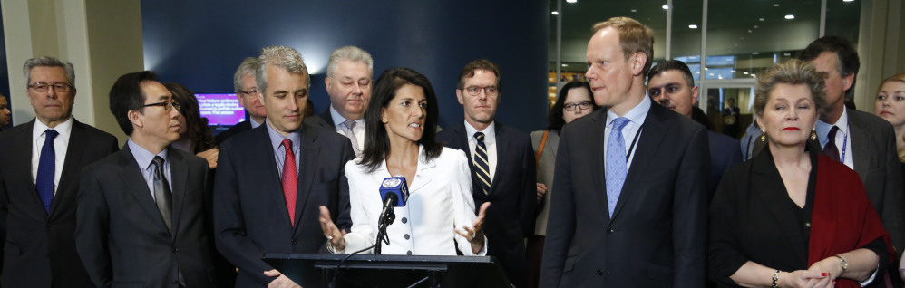 Surrounded by representatives from supporting countries, U.S. Ambassador to the United Nations Nikki Haley, center, speaks to reporters outside the General Assembly at U.N. headquarters Monday.