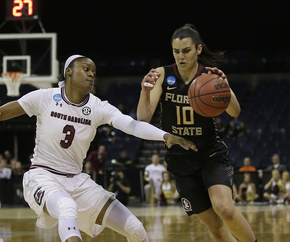 Florida State guard Leticia Romero, right, drives against South Carolina guard Kaela Davis during the first half of the Gamecocks' 71-64 win in a regional final Monday in Stockton, California.