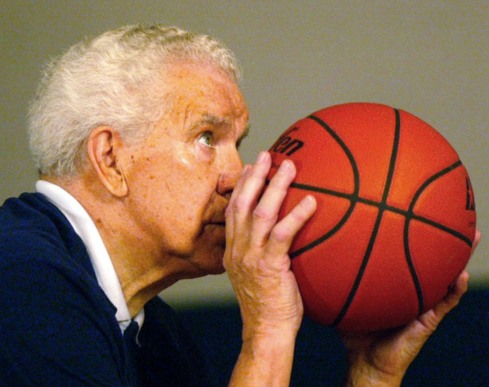 Keeping his shooting elbow in, Dr. Tom Amberry aims a free throw. Amberry, a California podiatrist, made history in 1993 when he shot 2,750 consecutive free throws. He died during the NCAA's March Madness season this year.