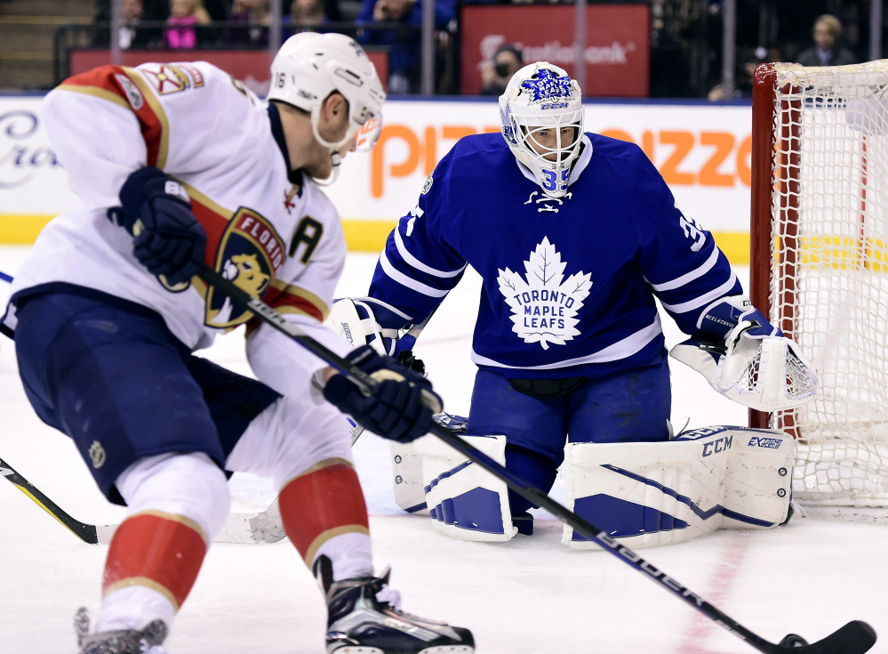 Aleksander Barkov of the Panthers looks for an opening as Leafs goalie Curtis McElhinney stays put in goal in the first period Tuesday night in Toronto.